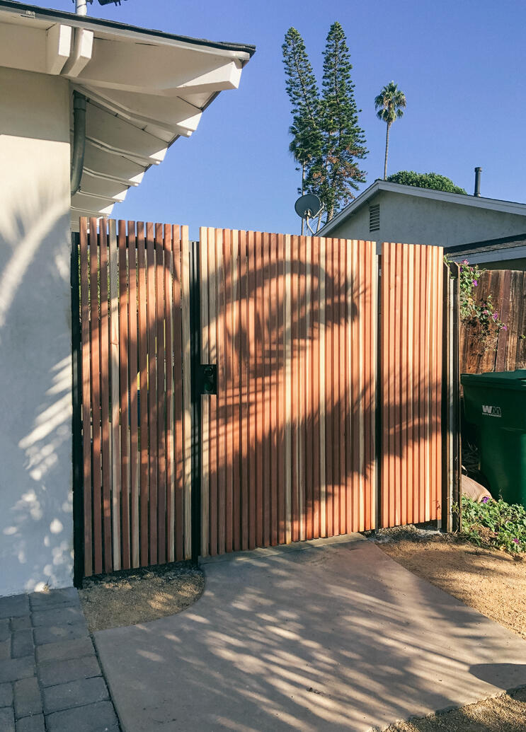 Metal gate and fence with redwood Metal gate and fence with redwood